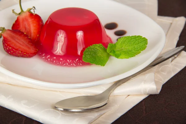 Plate with jelly and a spoon on a napkin, closeup — Stock Photo, Image