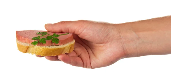 Sandwich con la salchicha y el perejil en la mano femenina — Foto de Stock