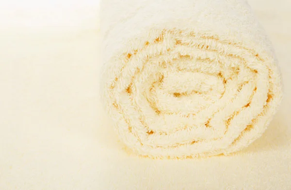 Fluffy towel close up, on a beige background — Stock Photo, Image