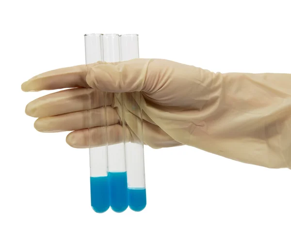 The hand holds a test tubes with blue liquid isolated on white — Stock Photo, Image