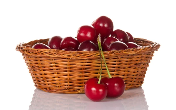 Basket with sweet cherries and two berries — Stock Photo, Image