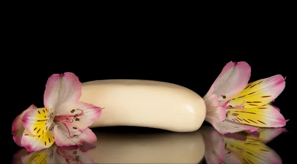 Beige toilet soap and the flower of alstroemeria isolated on black — Stock Photo, Image