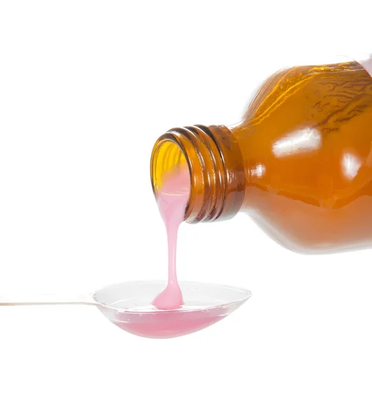 kaşık ile izole üzerinde beyaz pembe tıp yakın