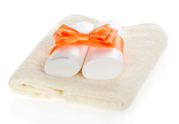 Set of cosmetics with a bright bow on a towel, isolated on white — Stock Photo, Image