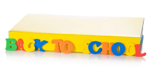 The book and set of plastic letters for the training, isolated on white — Stock Photo, Image