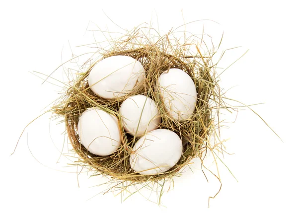 Eggs, hay in a bast basket, isolated on white — Stock Photo, Image