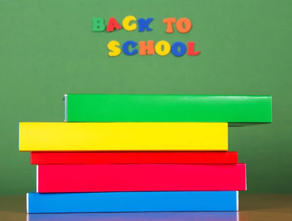 Stack of books and set of plastic letters — Stock Photo, Image