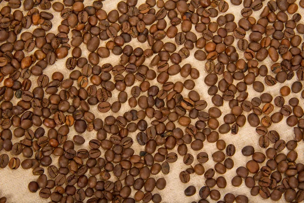 Coffee grains on a sacking. Background — Stock Photo, Image