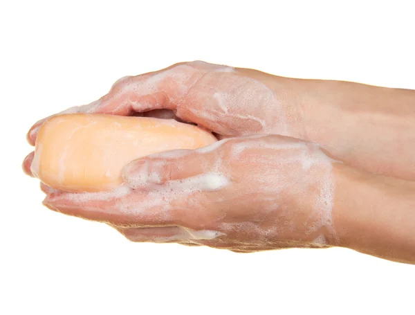 Pieza de jabón de tocador en las manos femeninas, aislado en blanco — Foto de Stock