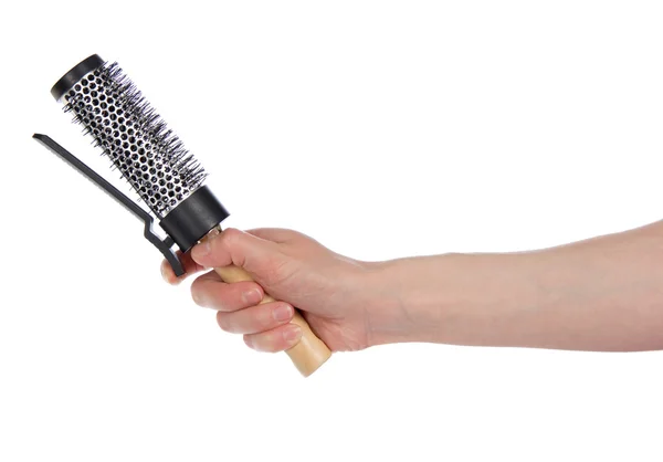 Escova de cabelo com um clipe em uma mão, isolada em branco — Fotografia de Stock