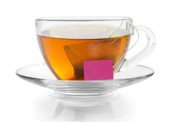 Transparante cup met thee op een schotel, geïsoleerd op wit — Stockfoto