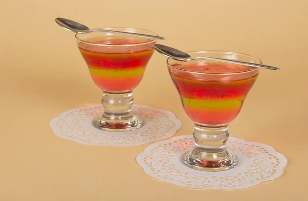 Two glasses of the jelly, two teaspoons on the beautiful napkins — Stock Photo, Image