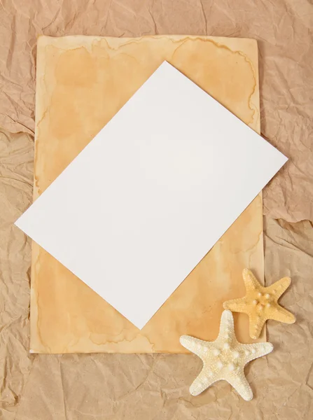 Old paper, two starfishes and blank card — Stock Photo, Image