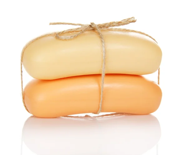 Two pieces of the toilet soap which have been tied up by a twine, isolated on white — Stock Photo, Image