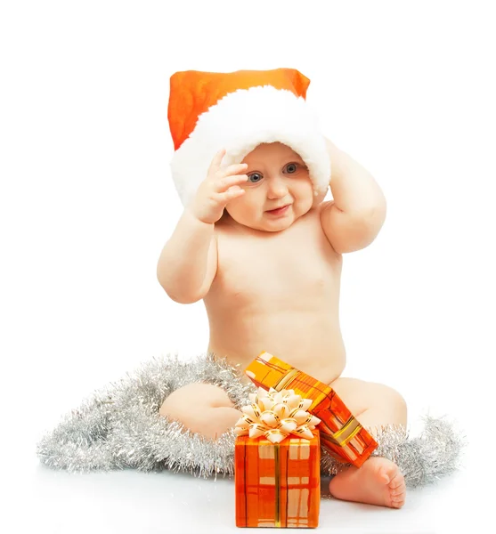 Positivity naked child in Santa Claus red hat with silver tinsel, colorful christmas festive gift isolated on white Royalty Free Stock Photos