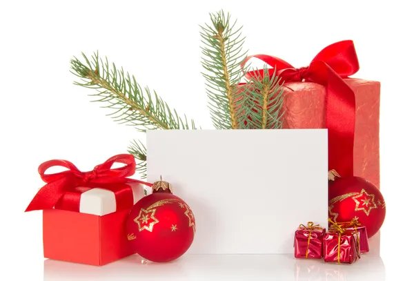 Christmas toys and gifts, fir-tree branch and empty card isolated on white — Stock Photo, Image