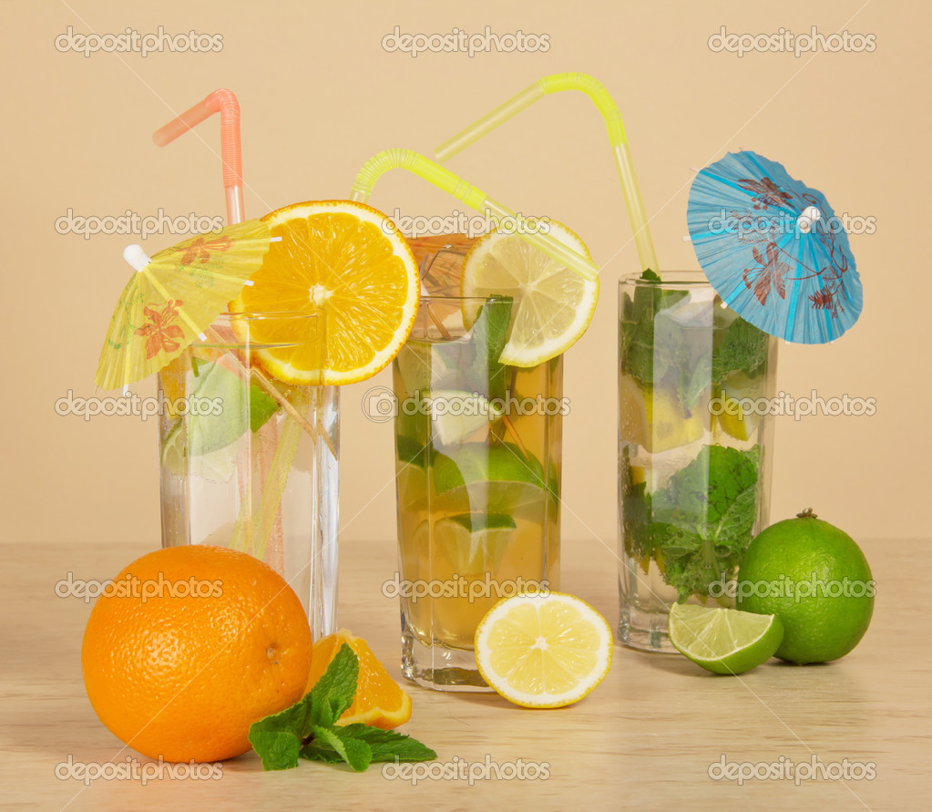 Cocktail with a straw and an umbrella, drink with an orange slice, tea