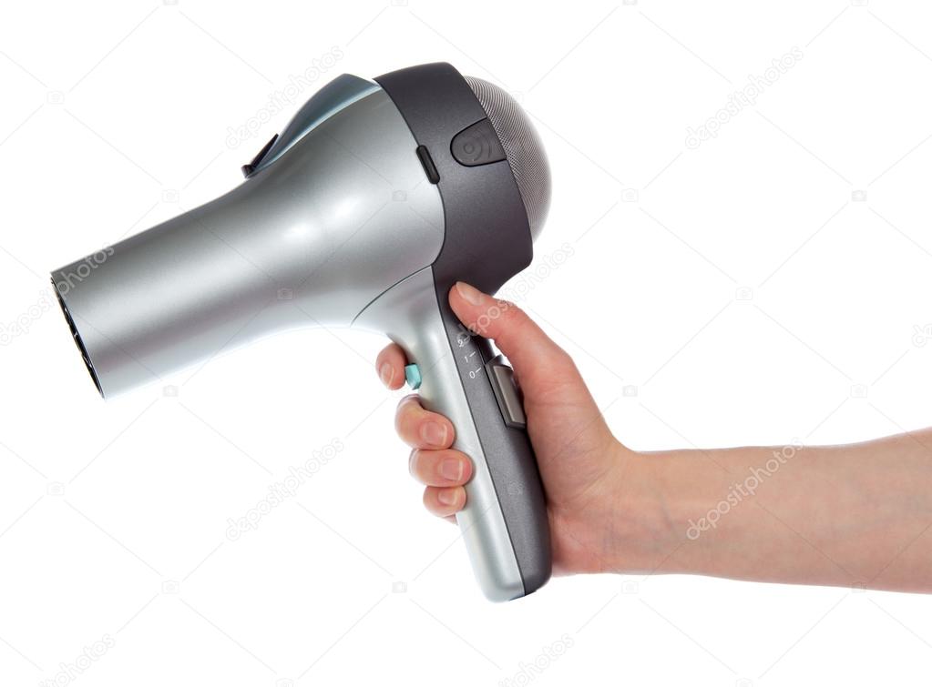 The hair dryer in a hand isolated on white
