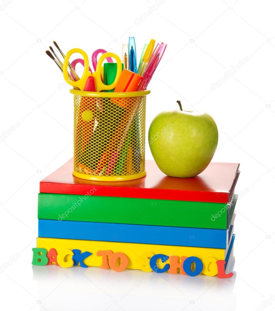 Pile of textbooks, tools in a support and the apple