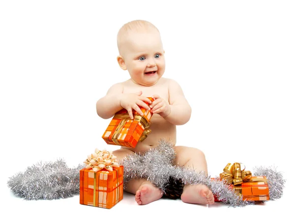 Joy child holds bright gift box with christmas silver tinsel isolated on white — Stock Photo, Image