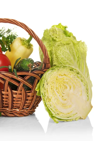 The whole cabbage, piece of cabbage, cucumber, greens and basket with the vegetables — Stock Photo, Image