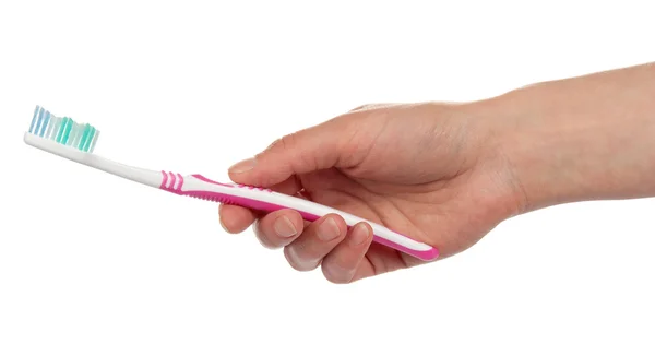 Toothbrush in the female hand, isolated on white — Stock Photo, Image