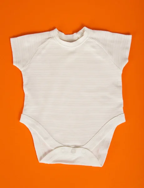 Baby clothes on an orange background — Stock Photo, Image