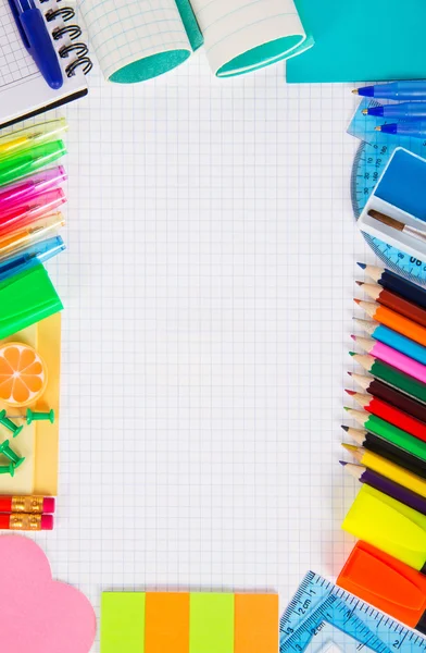 Exercise book leaf in a cage and a set of office goods — Stock Photo, Image