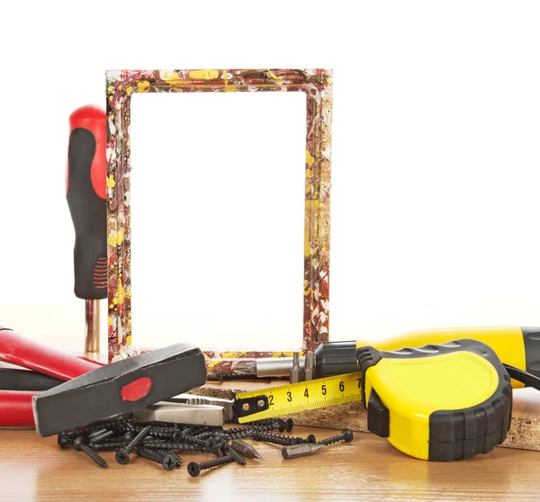 Tool kit and frame on a table — Stock Photo, Image