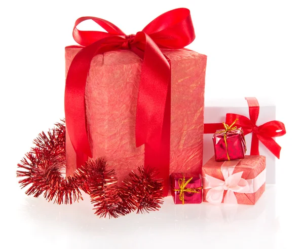 Different gift boxes with ribbons and bows, tinsel — Stock Photo, Image