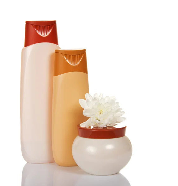 Shower gel, shampoo and cream jar with a flower, isolated on white — Stock Photo, Image