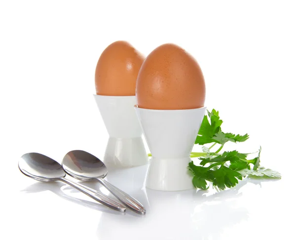 Support with eggs, teaspoons and the parsley, isolated on white — Stock Photo, Image