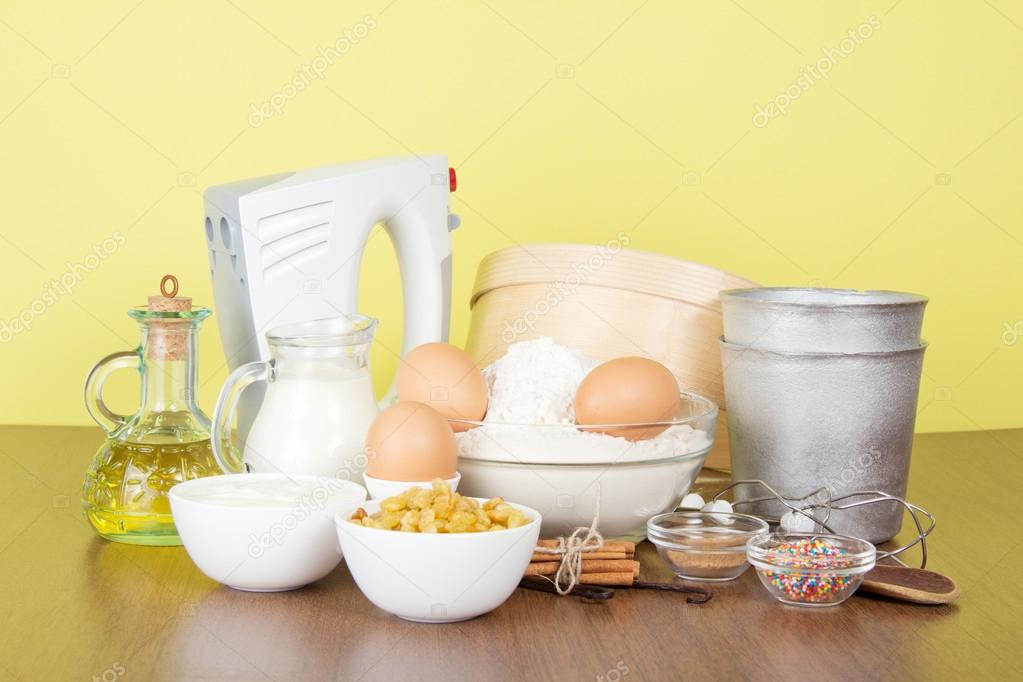 Set of products and an Easter cake baking dish, on a yellow background