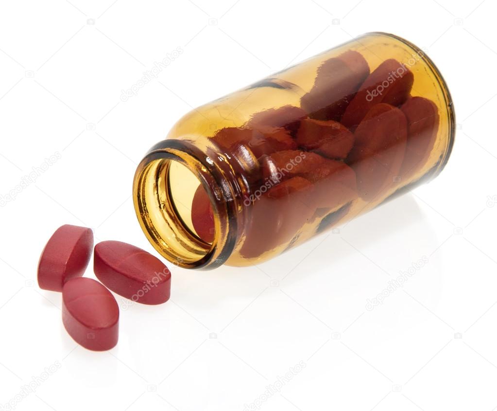 Red tablets, bottle isolated on white