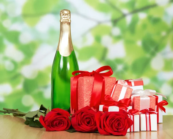 Gift in box, champagne and red rose close-up — Stock Photo, Image