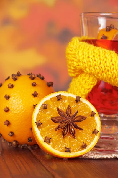Glass of mulled wine in yellow scarf close-up — Stock Photo, Image