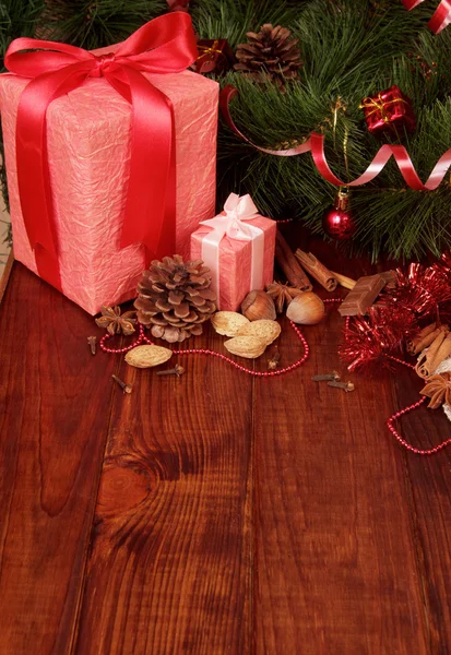 Nuts, chocolate and two Christmas gift — Stock Photo, Image