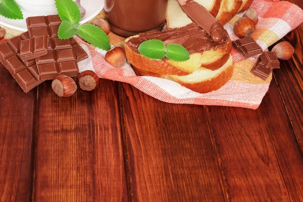 Hands spread chocolate paste on toast — Stock Photo, Image