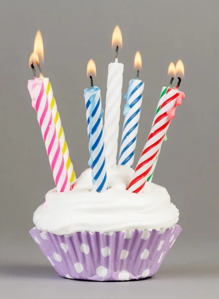 Cupcake with colorful candles — Stock Photo, Image