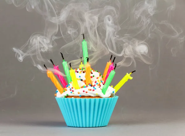 Cupcake with colorful candles — Stock Photo, Image