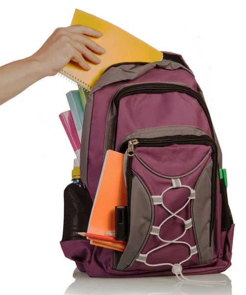 Hand with exercise book and bag — Stock Photo, Image