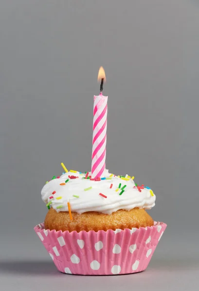 Cupcake with cream and candle — Stock Photo, Image