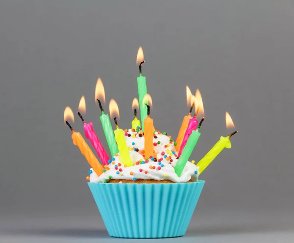 Cupcake with colorful candles — Stock Photo, Image