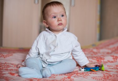 Toddler crawling on the bed. clipart