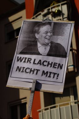 FRANKFURT, GERMANY - Sep 24, 2021: Chancellor candidate Armin Laschet on a protest poster of a Fridays for Future demonstration. Referring to his laughter in the flood disaster area. clipart