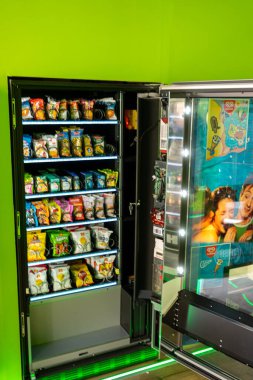 MILAN, ITALY - Sep 02, 2021: A vertical shot of snacks vending machine in a self-service grab shop in Milan, Italy clipart