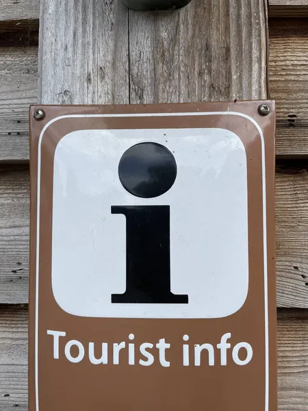 Closeup Shot Information Sign Plate Tourist Info Writing Wooden Wall — Stock Photo, Image