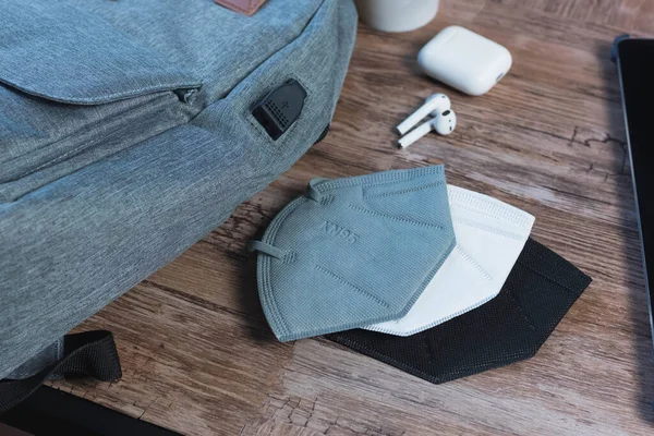 Some face masks on a desk with office elements around