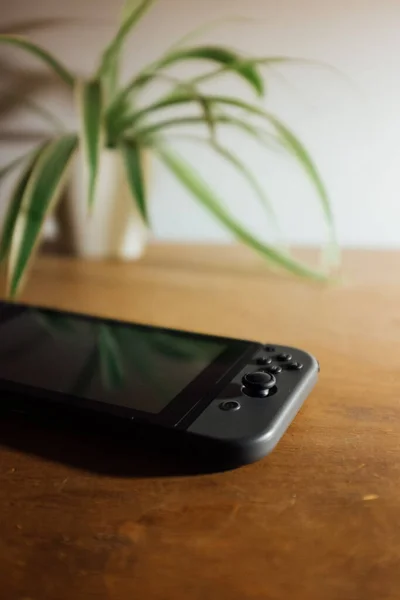 A vertic shot of a black Nintendo Switch Console