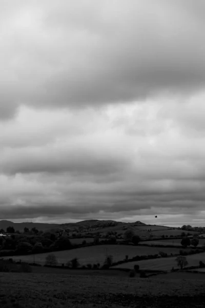 Grayscale Shot Thick Cloudscape Farm Field — Stock Photo, Image